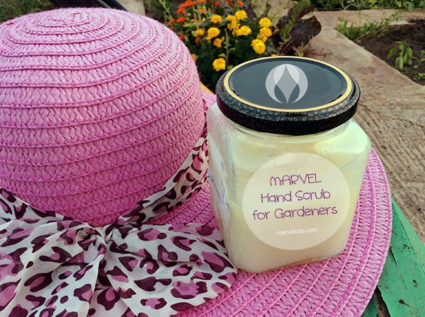 jar of homemade hand scrub on table with hat